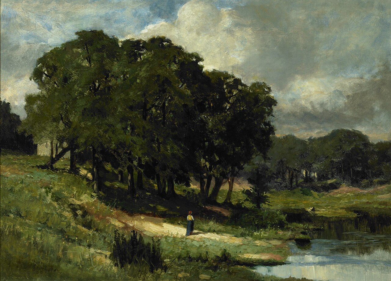 A woman standing beside still water and trees